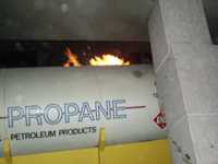 Flames behind propane tank truck slid into pillars